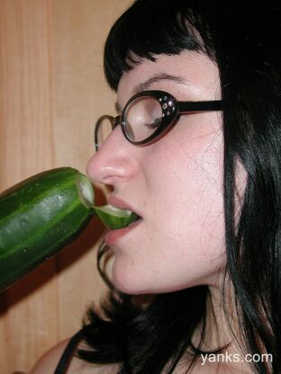 girl playing with cucumber